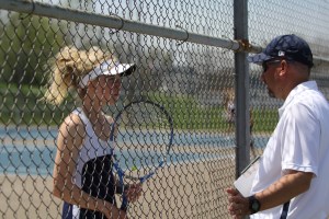 A Mooresville tennis player talks to the head coach during the Mooresville Invitational. (James Figy/The Reporter-Times)