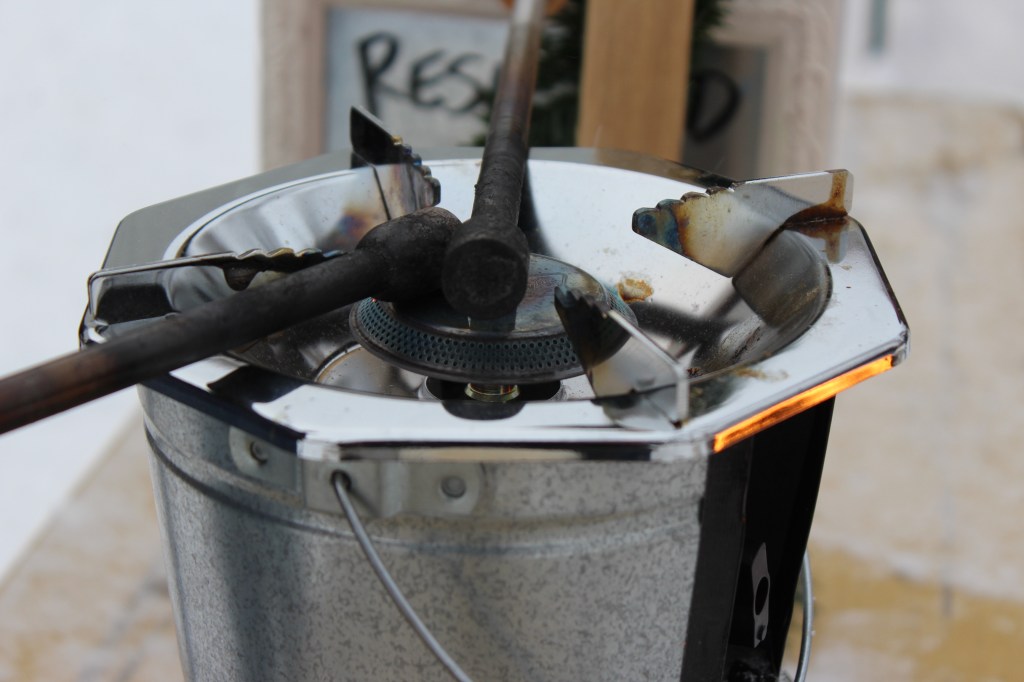 A propane burner with beer poking equipment heating up.