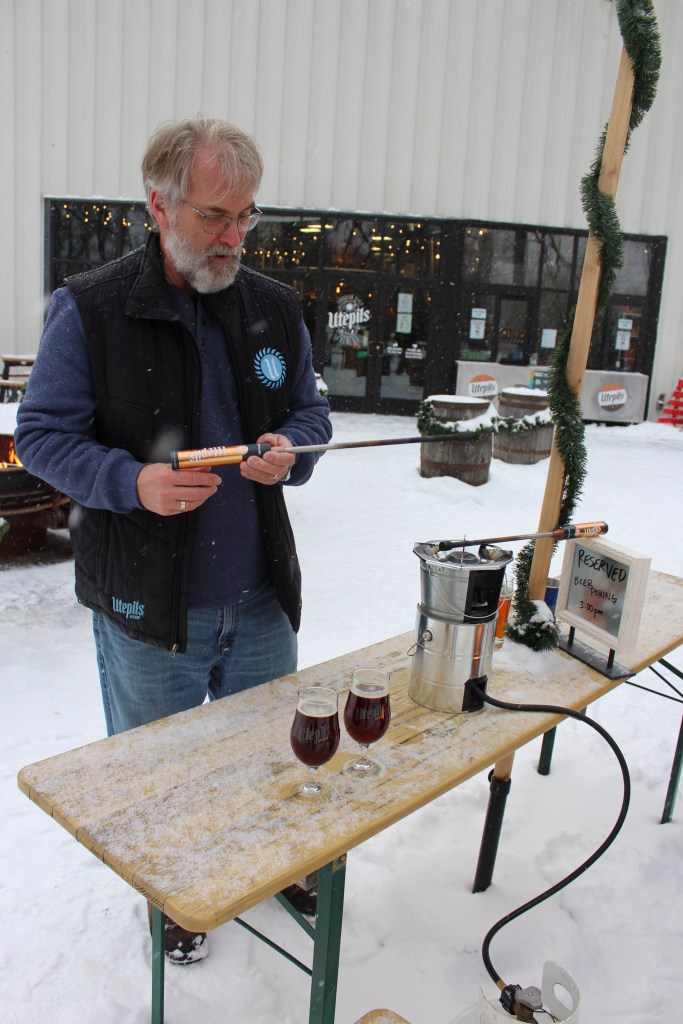 Dan Justesen of Utepils shows off the poking irons, customized with brewery tap handles.